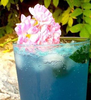 Cocktail de Mojito à la phycocyanine agrémenté d'une fleur rose