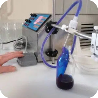Remplissage d’un flacon en verre avec une solution de phycocyanine dans un laboratoire.